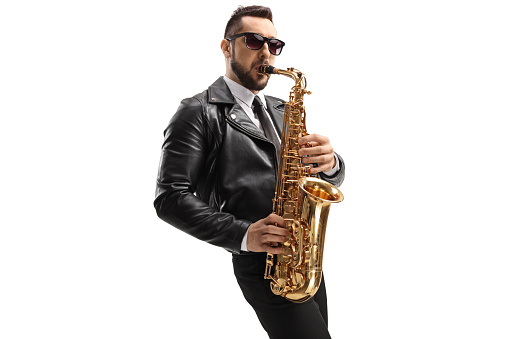 Guy in a leather jacket playing a sax isolated on white background