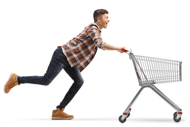istock Young man running with an empty shopping cart 1256758045