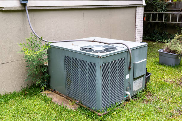istock Package Air Conditioner system next to a home 1256759648