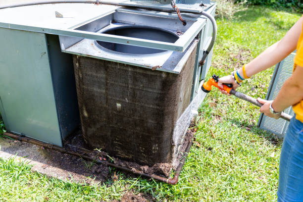 person cleaning dirty condenser coils on an air conditioner system - condenser imagens e fotografias de stock