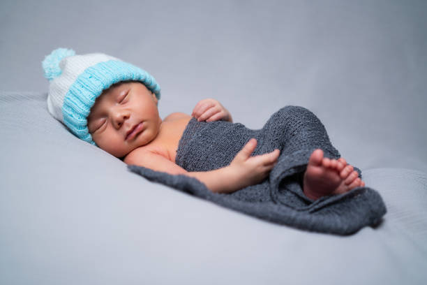istock newborn baby boy sleeping 1256759835
