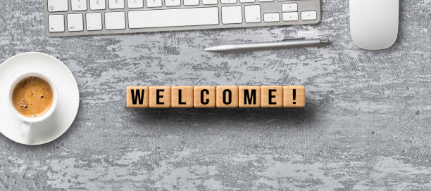 cubes with message WELCOME and office items cubes with message WELCOME and office items on concrete background welcome sign stock pictures, royalty-free photos & images