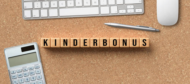 istock cubes with German word for CHILD BONUS and office equipment 1256761006