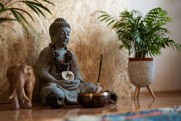 Spiritual awakening Statue of Buddha and a small meditation bell on the floor. buddha photos stock pictures, royalty-free photos & images