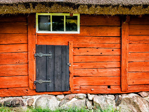 Door in old wooden log house with natural patterns. Vintage wooden house