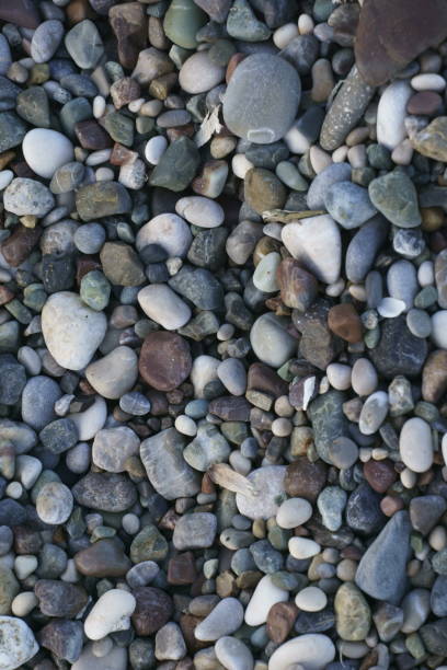 istock Closeup view of small stones on the beach with colorful pattern 1256762117