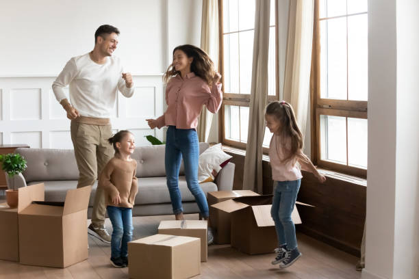 istock Happy family with two daughters celebrating moving day 1256762262