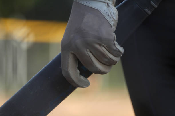 istock Softball Player Holds Bat in On-Deck Circle 1256762591