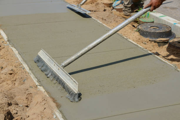 istock Workmen finish and smooth concrete surface on new cement sidewal 1256767945