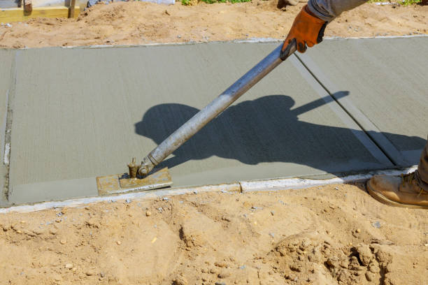 istock Worker plastering the concrete cement during sidewalk 1256767946