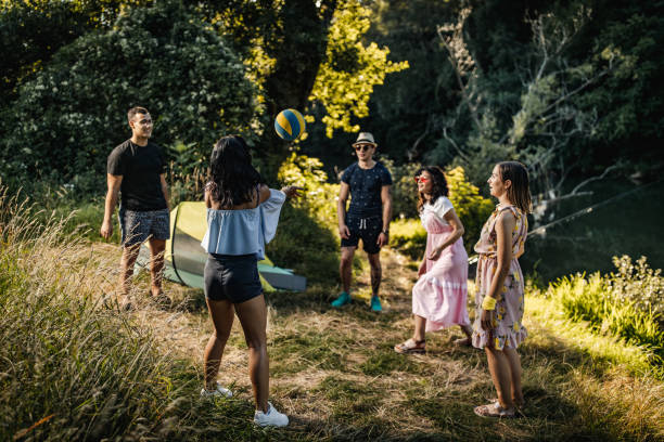 istock Group of people playing volleyball on riverbank 1256768155