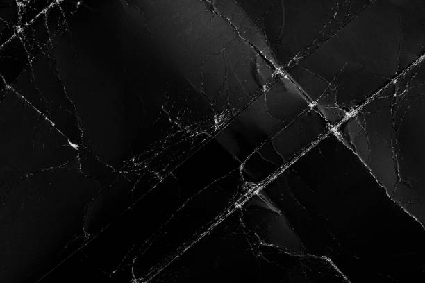 istock Dark damaged folded black cardboard with creases and defects 1256769070
