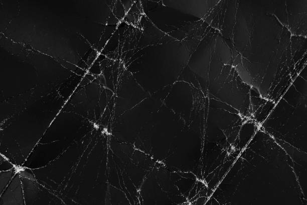 istock Damaged black folded paper with wrinkles and defects. Wrapping dark folded old cardboard 1256769075
