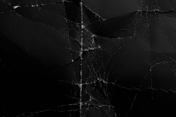 istock Abstract worn black background from crumpled paper 1256769345