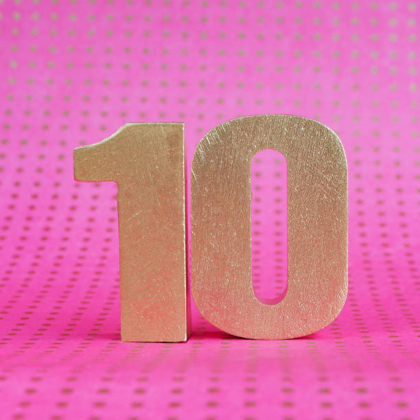 istock Golden volumetric number 10 on a bright pink polka dot background. copy space. 1256770610