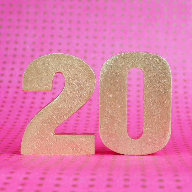 istock 20 volumetric golden number on a bright pink polka dot background. copy space. 1256770621
