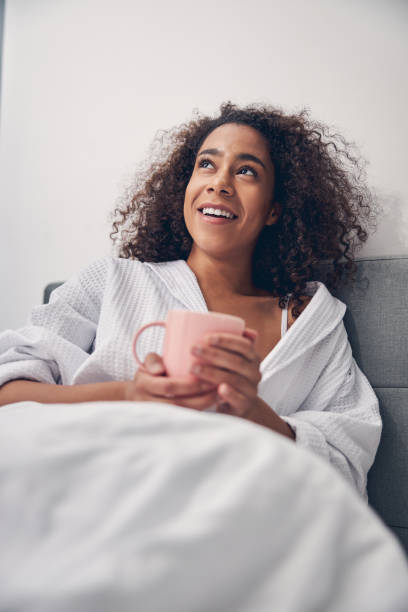 istock Smiling young female staring at the ceiling 1256771724