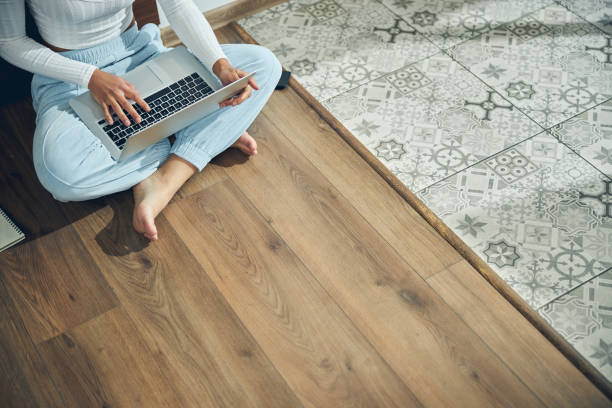 istock Young woman working on her laptop indoors 1256771746