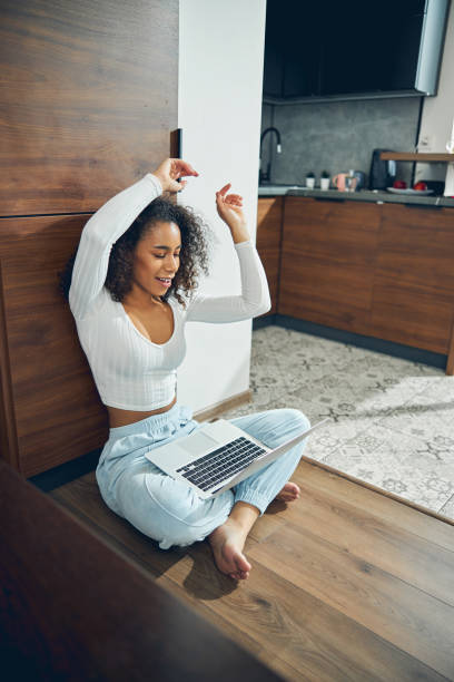 istock Woman enjoying a music video on her computer 1256771757