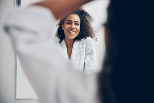 istock Cheerful female in a bathrobe standing in the bathroom 1256771789