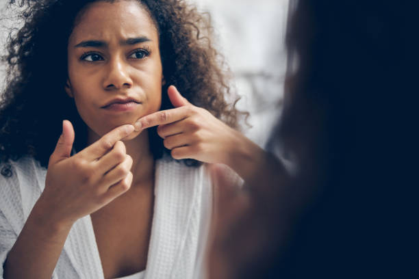 istock Serious young woman performing a beauty procedure 1256771798