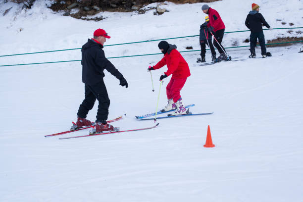 Children having ski classes Some children having ski class with an instructor in a ski slope during the winter in Ushuaia Patagonia Argentina ski instructor stock pictures, royalty-free photos & images
