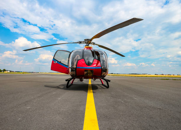 Berlin, Germany - June 27, 2020: Frontal view of a red Eurocopter EC130/Airbus Helicopters H130, a single engine light utility helicopter, parked with an open door.