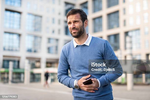 Man In The City Having Stomachache Stock Photo - Download Image Now - Stomachache, Men, Pain