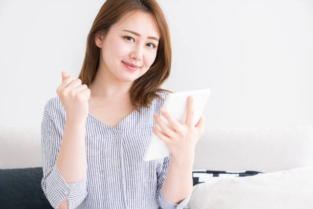 istock asian woman to see a tablet computer 1256779300