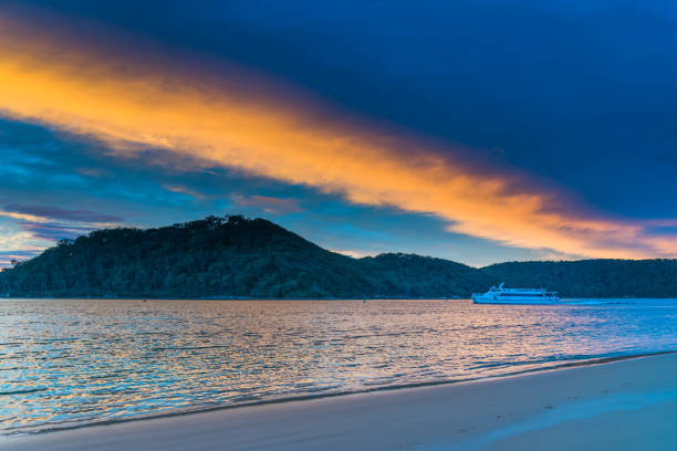 Sunrise Seascape with Cloud Filled Sky at Ettalong Beach on the Central Coast, NSW, Australia.