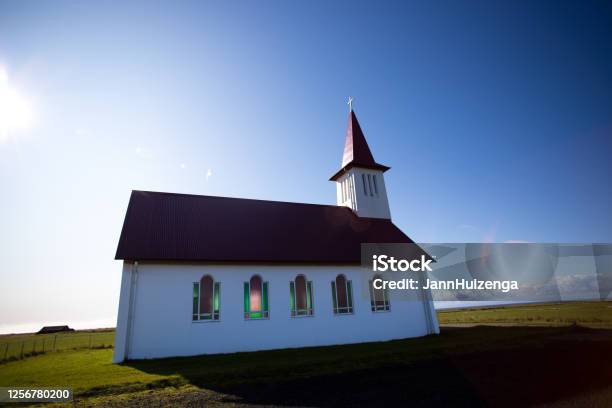 Vik Iceland Red And White Sunlit Church Lens Flare Stock Photo - Download Image Now