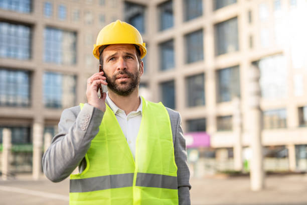 istock Serious mid adult engineer talking on phone. 1256781733