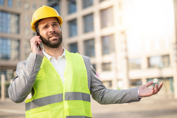 istock Frustrated mid adult engineer talking on phone. 1256782265