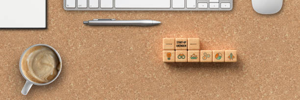 istock cubes with word START-UP and tech icons with office equipment 1256788258