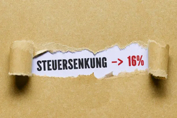Photo of torn paper revealing information about the temporary German VAT reduction in 2020 to 16%