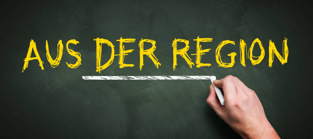 istock hand is writing German message for REGIONAL PRODUCTION on a chalkboard 1256789303