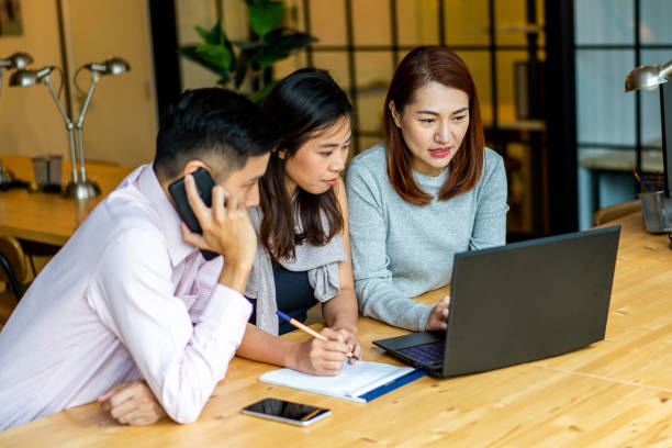 istock Asians Millennials discussing work in coworking space. 1256794622