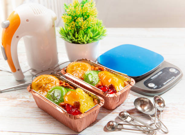 fruitcake in a loaf pan on a wooden table