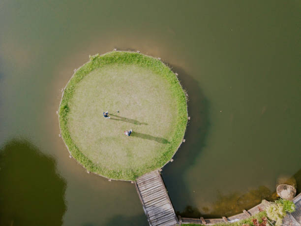 drone point of view golfer playing golf in golf course in melaka, malaysia
