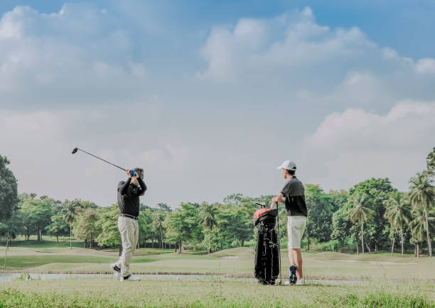istock an asian chinese man playing golf tee off while his son watching and learning in melaka golf course malaysia 1256800423