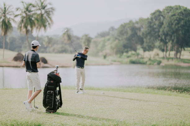 istock an asian chinese man playing golf tee off while his son watching and learning in melaka golf course malaysia 1256800473
