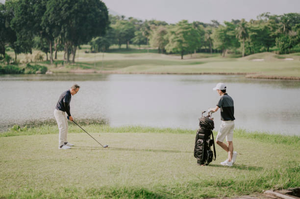 istock an asian chinese man playing golf tee off while his son watching and learning in melaka golf course malaysia 1256800489