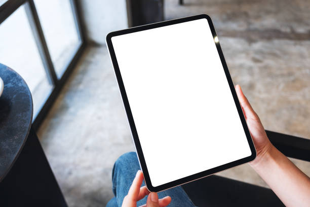 istock a woman holding black tablet pc with blank white desktop screen 1256802544