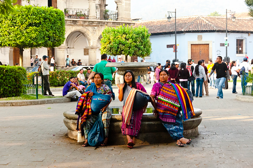 Antigua, Guatemala - May 02, 2011: Three traditionally dressed women in the main town plaza.