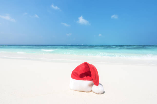 istock Santa Claus Hat on the tropical beach 1256805928
