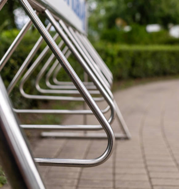 istock steel parking for bicycles in the park. background - thick sheared bushes 1256807500