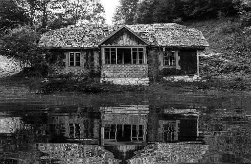 Abandoned house. Water reflection. Lake. Swamp