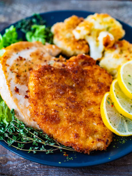 istock Fried pork chop and vegetable salad on wooden table 1256807571