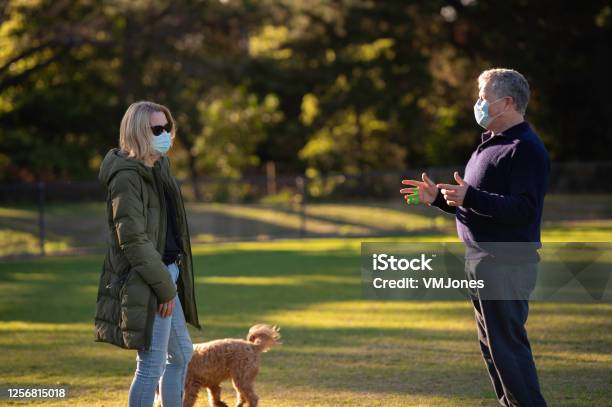 Seniors Wearing Masks Walking Dogs Stock Photo - Download Image Now - Coronavirus, Dog Walking, Protective Face Mask
