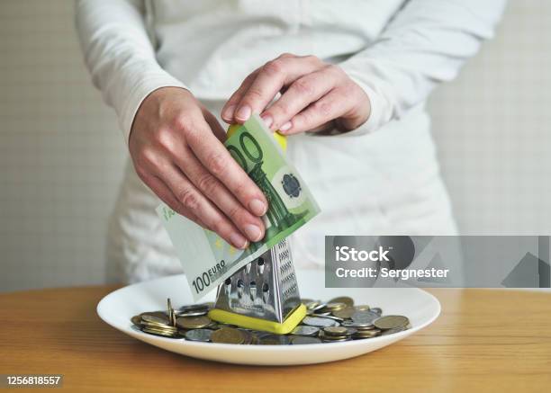 Exchange Euros For Cents Using A Grater Concept On The Theme Of Money Stock Photo - Download Image Now